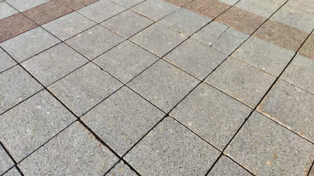 Rows and lines of square sidewalk gray tiles on floor outside or indoors. Street path. Abstract background, texture, pattern, frame, space for text and copy space