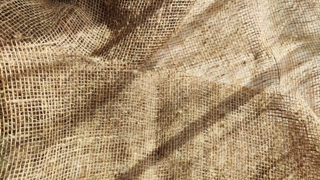 Natural fabric texture, frame and background of burlap. Rough crumpled burlap background. Selective focus