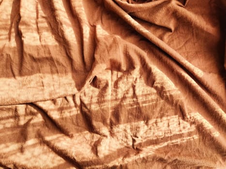 Abstract background and texture of crumpled brown fabric. Texture, pattern, frame and copy space