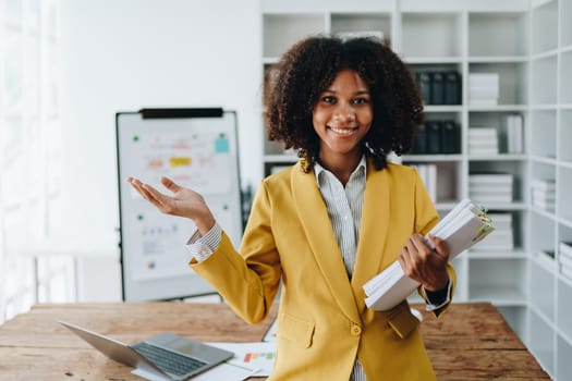 American African business woman using document, computer laptop, calculator, paperwork, documents, in winner and smiling Happy to be successful achievement success. finance and investment concepts.