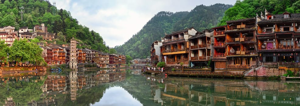 Chinese tourist attraction destination - Feng Huang Ancient Town (Phoenix Ancient Town) on Tuo Jiang River on sunset. Hunan Province, China