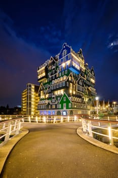 ZAANDAM, NETHERLANDS - MAY 21, 2018: Inntel Hotel in Zaandam illuminated at night. Design of 12-storey tall building opened in 2009 is the result of stacking a series of traditional Dutch houses
