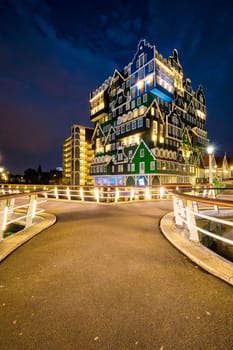 ZAANDAM, NETHERLANDS - MAY 21, 2018: Inntel Hotel in Zaandam illuminated at night. Design of 12-storey tall building opened in 2009 is the result of stacking a series of traditional Dutch houses