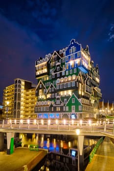 ZAANDAM, NETHERLANDS - MAY 21, 2018: Inntel Hotel in Zaandam illuminated at night. Design of 12-storey tall building opened in 2009 is the result of stacking a series of traditional Dutch houses