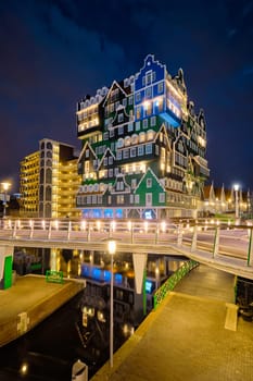 ZAANDAM, NETHERLANDS - MAY 21, 2018: Inntel Hotel in Zaandam illuminated at night. Design of 12-storey tall building opened in 2009 is the result of stacking a series of traditional Dutch houses