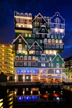 ZAANDAM, NETHERLANDS - MAY 21, 2018: Inntel Hotel in Zaandam illuminated at night. Design of 12-storey tall building opened in 2009 is the result of stacking a series of traditional Dutch houses