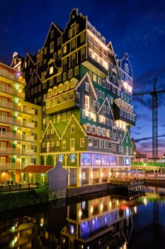 ZAANDAM, NETHERLANDS - MAY 21, 2018: Inntel Hotel in Zaandam illuminated at night. Design of 12-storey tall building opened in 2009 is the result of stacking a series of traditional Dutch houses