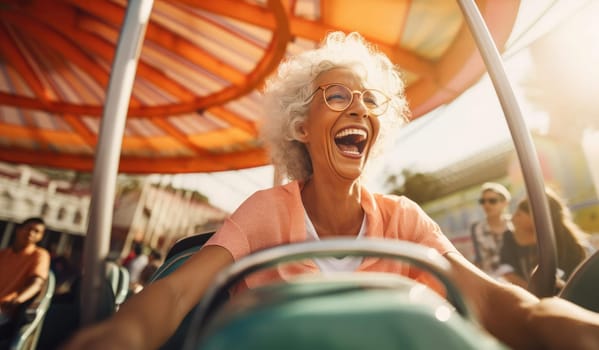 Joyful elderly woman rides in an amusement park. Expressive emotions