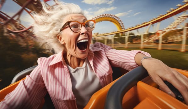 Joyful elderly woman rides in an amusement park. Expressive emotions