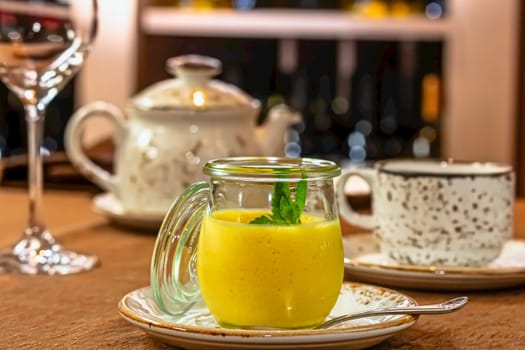 A citrus curd in a glass jar and citrus fruits on a linen tablecloth. Rustic style, selective focus.