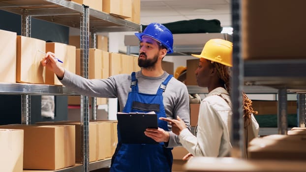 Multiethnic group of people working in storage room with cardboard boxes and stock products, shipping oders. Depot workers checking goods and merchandise in packages, delivery service.