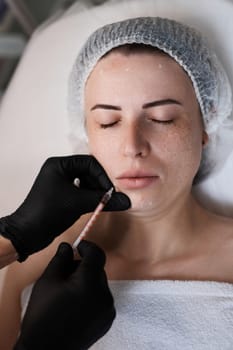 woman receives cosmetic botox injection in face. Woman in beauty salon. plastic surgery.