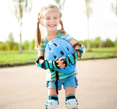 Little girl in roller skates at a park