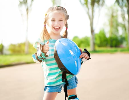 Little girl in roller skates at a park