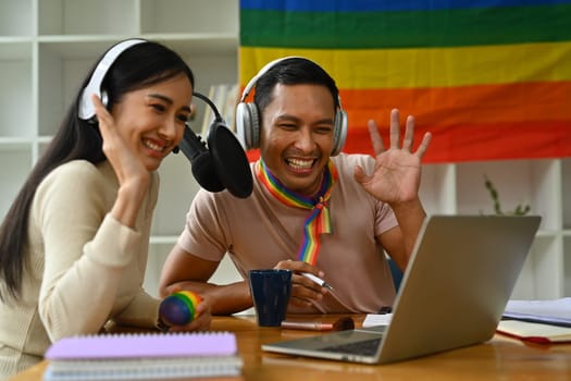 Cheerful young woman and biracial transgender man recording podcast from home studio. Radio, podcasts and blogging.