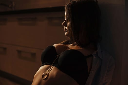 A sexy brunette in a black bra dances a striptease. beautiful breasts. girl in underwear.