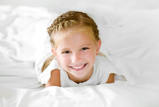 Adorable little girl wake up in her bed