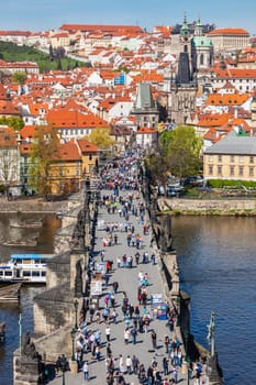 PRAGUE, CZECH REPUBLIC - APRIL 26, 2012: Charles Bridge over Vltava river crowded with tourists in Prague, Czech republic
