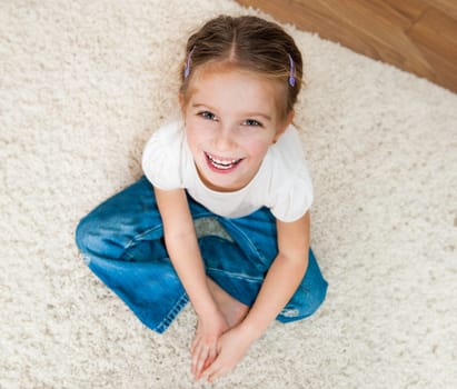 cute little girl sitting on the floor