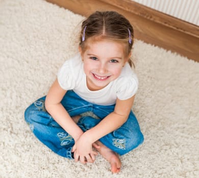 cute little girl sitting on the floor. top view