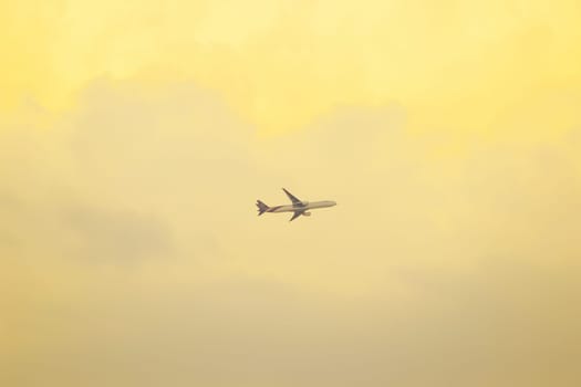 The plane on the sky and the sunset