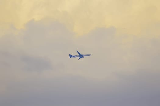 The plane on the sky and the sunset