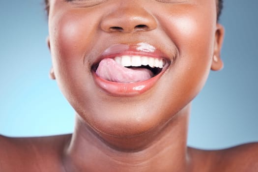 Woman, lips or closeup tongue on dental teeth, blue background or studio of cosmetic veneers results. Emoji, model or fun facial expression in wellness, gum or clean mouth hygiene in grooming routine.
