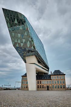 ANTWERP, BELGIUM - MAY 27, 2018: Antwerp port administration headquarters, designed by famous iranian architect Zaha Hadid, Antwerpen, Belgium which was her last project in stormy weather