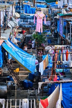 MUMBAI, INDIA - OCTOBER 31, 2019: Dhobi Ghat Mahalaxmi Dhobi Ghat is open air laundromat lavoir in Mumbai, India with laundry drying on ropes. Now signature landmark tourist attractions of Mumbai