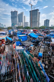 MUMBAI, INDIA - OCTOBER 31, 2019: Dhobi Ghat Mahalaxmi Dhobi Ghat is open air laundromat lavoir in Mumbai, India with laundry drying on ropes. Now signature landmark tourist attractions of Mumbai