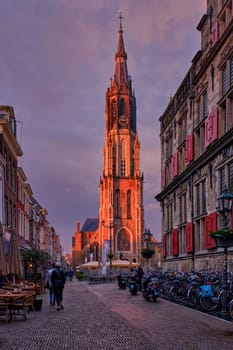 Delft, Netherlands - May 12, 2017: Nieuwe Kerk New Church protestant church on Delft Market Square Markt with dramatic sky on sunset. Delft, Netherlands