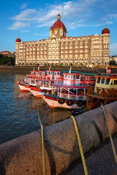 MUMBAI, INDIA - OCTOBER 31, 2019: Tourist boats in front of the famous Taj Hotel in the morning