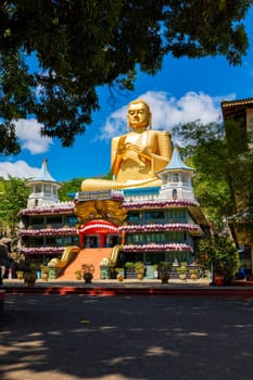 Dambulla, Sri Lanka - September 24, 2009: Golden Buddha temple with gold Buddha on roof, Dambulla, Sri Lanka. Golden Temple of Dambulla is a UNESCO World Heritage Site