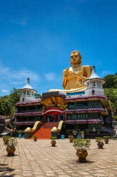 Dambulla, Sri Lanka - September 24, 2009: Golden Buddha temple with gold Buddha on roof, Dambulla, Sri Lanka. Golden Temple of Dambulla is a UNESCO World Heritage Site