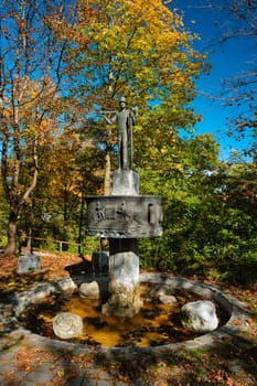 Bad Tolz, Germany - October 15, 2019: Lumberjack statue and fountain in park in Bad Tolz, Bavaria, Germany