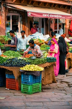 Jodhpur, India - November 14, 2019: Local indian people buying food shopping in vegetable and fruit market in Sadar Market. Jodhpur, Rajasthan, India