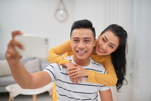 The happy couple making a selfie in livingroom
