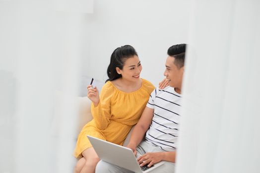 Young Asian handsome man spend girlfriend online shopping with credit card