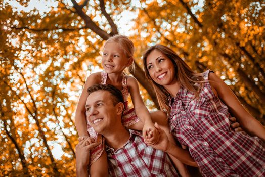 Beautiful young family enjoying a walk in the forest.