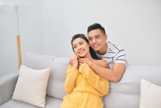 Young couple on the sofa enjoying a movie together