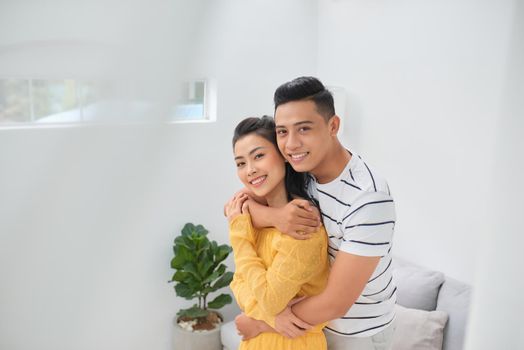 Romantic young couple embracing in living room