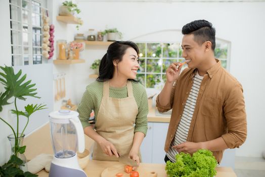 Attractive couple is cooking on kitchen.