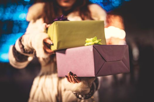 Close-up of a girl with gift in the city street at the New Year's eve. 