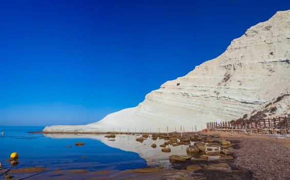 View of the limestone white cliffs with beach at the Scala dei Turchi in English Stair of the Turks near Realmonte in Agrigento province. Sicily, Italy