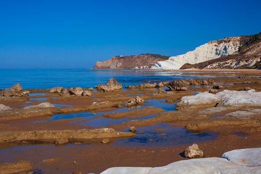 View of the limestone white cliffs with beach at the Scala dei Turchi in English Stair of the Turks near Realmonte in Agrigento province. Sicily, Italy