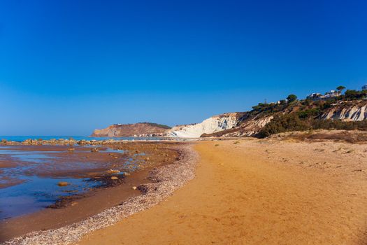 View of the limestone white cliffs with beach at the Scala dei Turchi in English Stair of the Turks near Realmonte in Agrigento province. Sicily, Italy