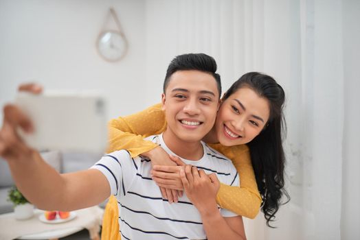 The happy couple making a selfie in livingroom