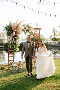 wedding ceremony of the newlyweds in a country cottage on a green hill