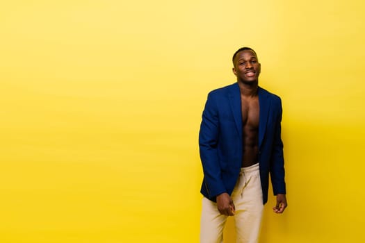 Laughing single handsome young African man over a red yellow background with copy space