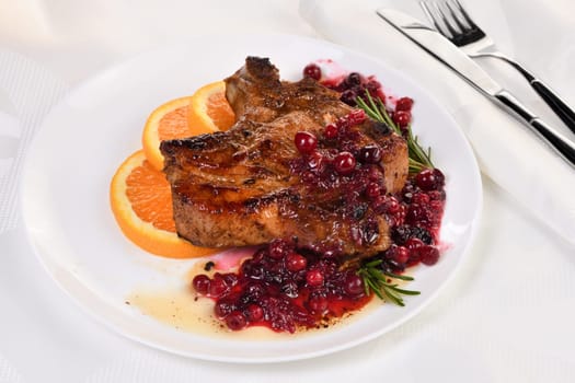 Fried pork chops served with cranberry sauce with orange and rosemary. They are elegant for a lunch or dinner party.